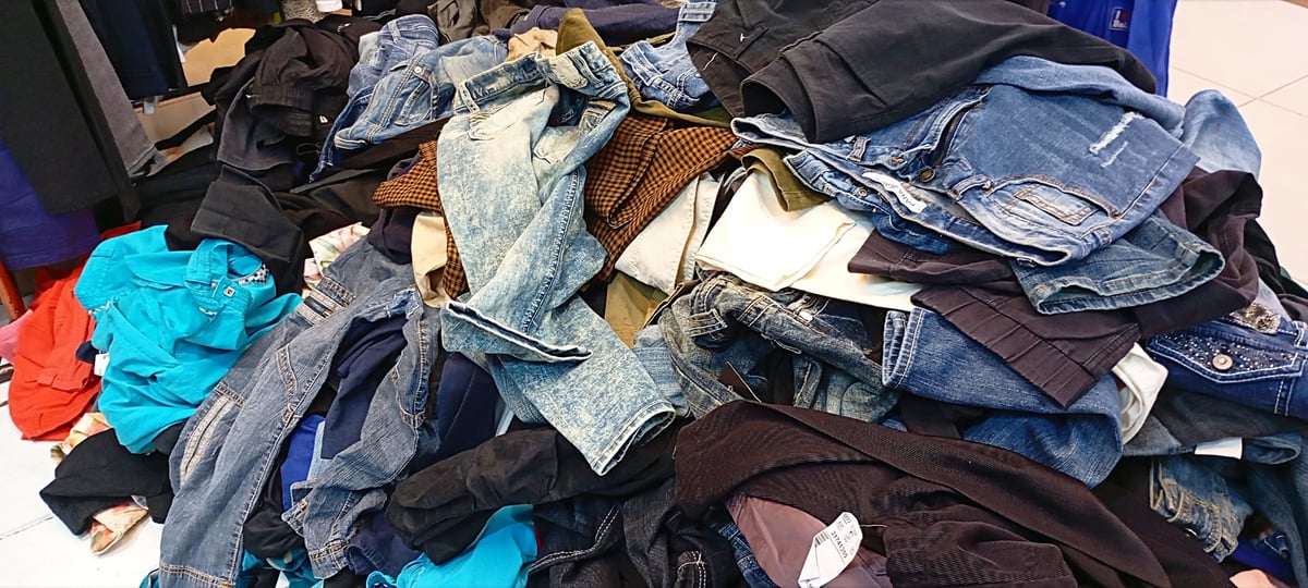 Secondhand branded clothes on display in a shop